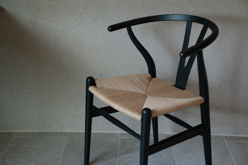 A chair set against a plaster wall