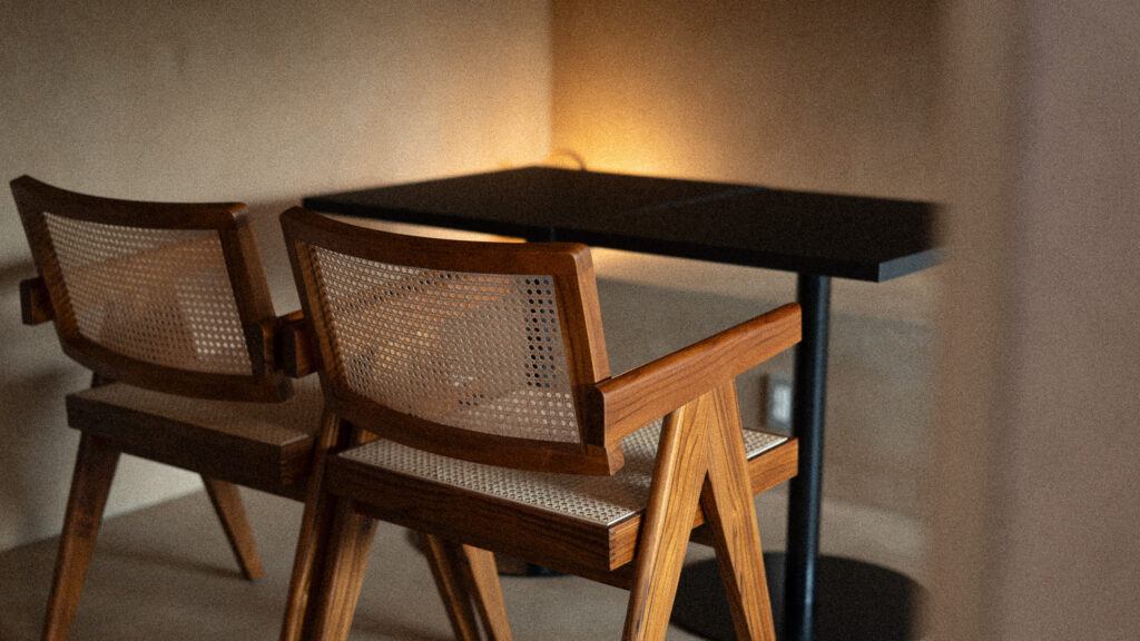 A chair and table under the lamp light