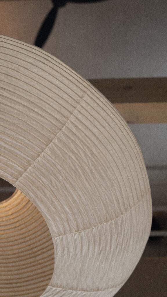 A washi paper lamp hanging from the ceiling